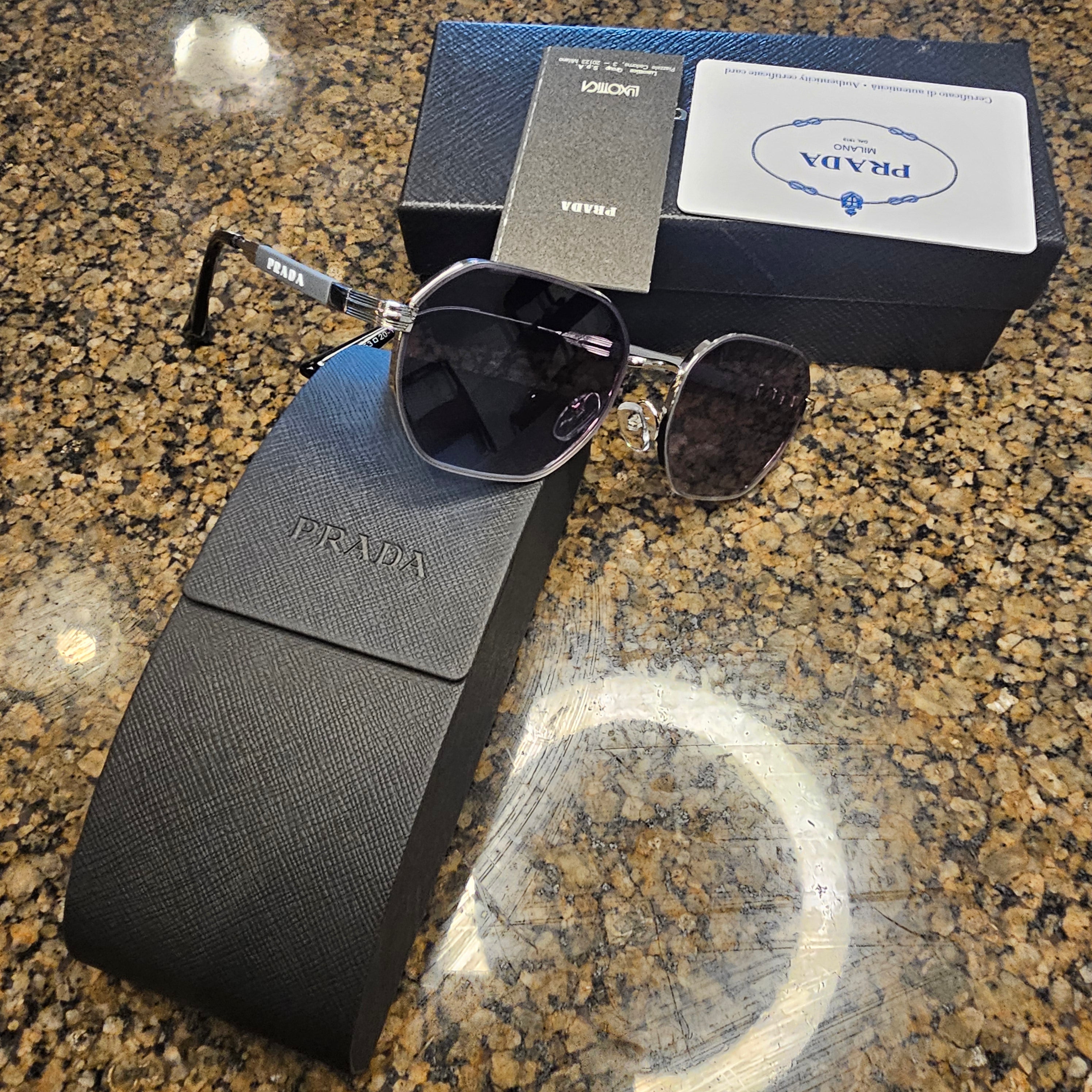 The Prada 0PR 56YS-1AB5S0 sunglasses