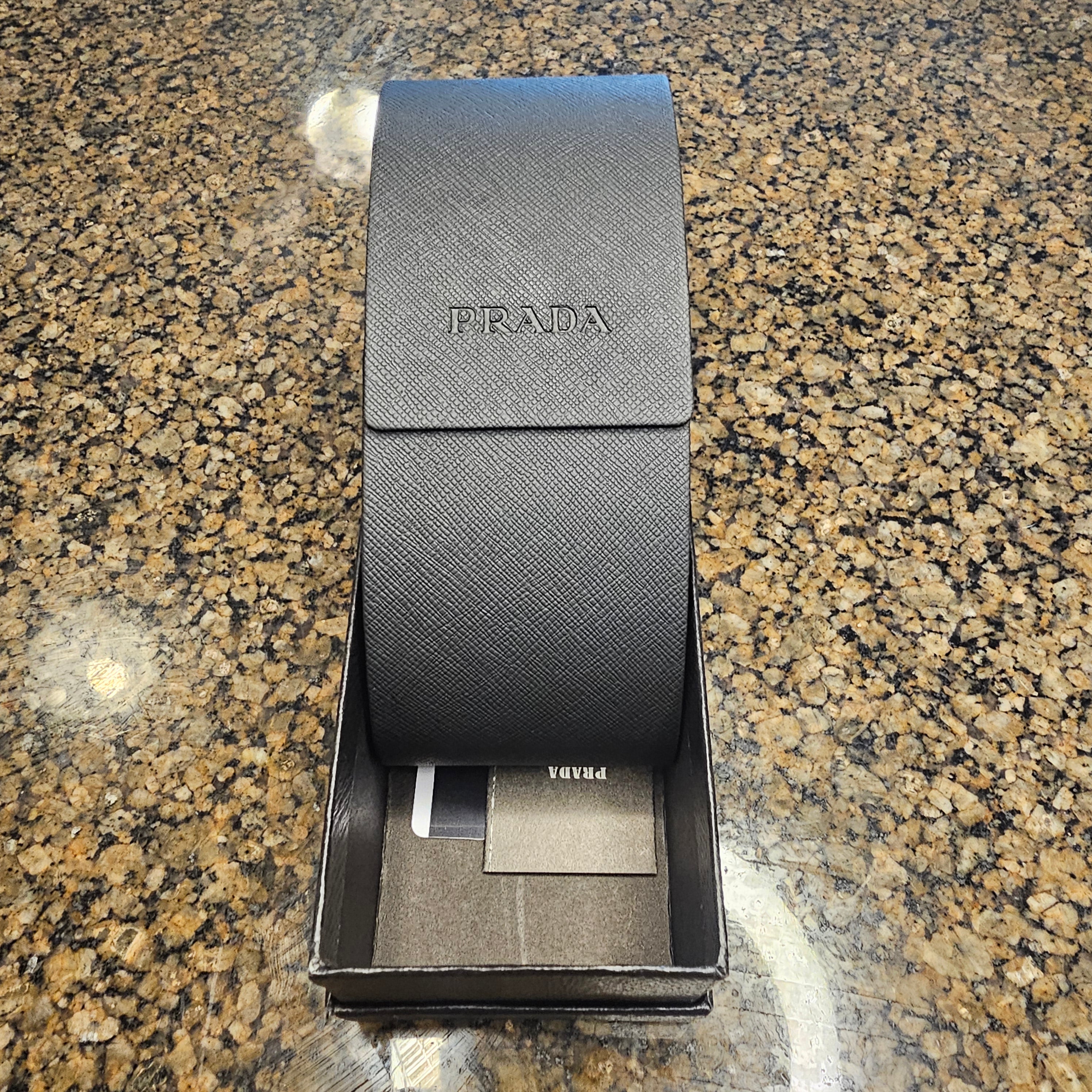 The Prada 0PR 56YS-1AB5S0 sunglasses